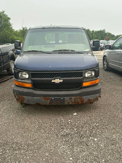 Rusty blue Chevrolet Express van scrap car disposal in North York, Toronto