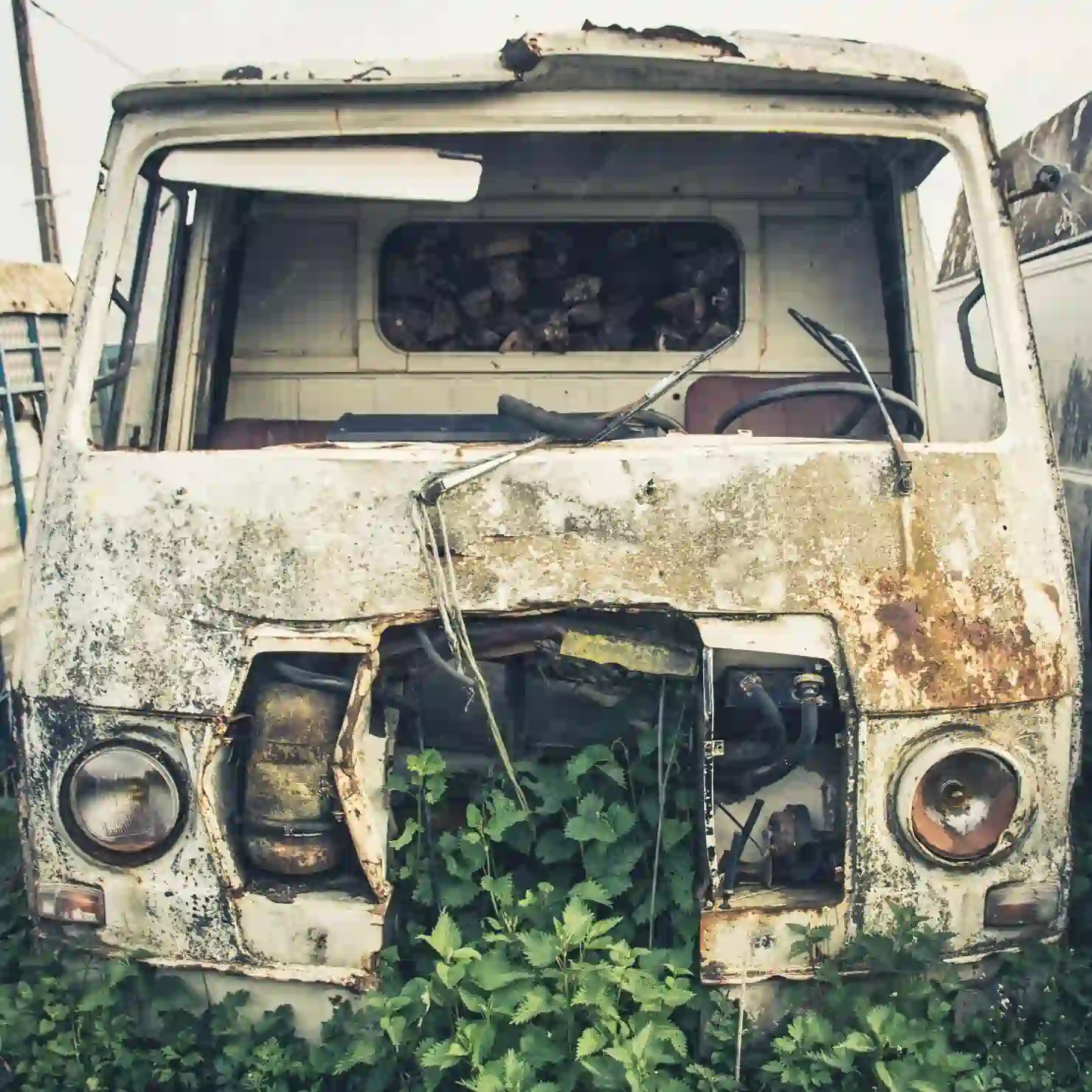 scrap van in a field