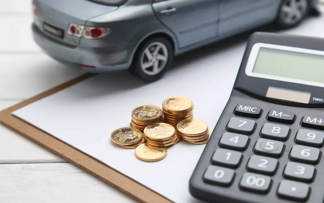 A toy car, gold coins, and a calculator on a clipboard representing junk car tax implications in Canada