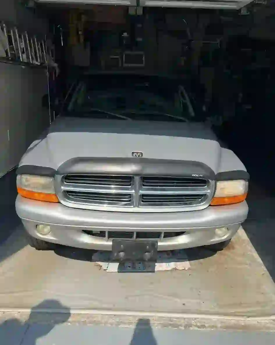 Old silver Dodge Durango SUV parked inside garage – get cash for junk cars in Toronto, free pickup