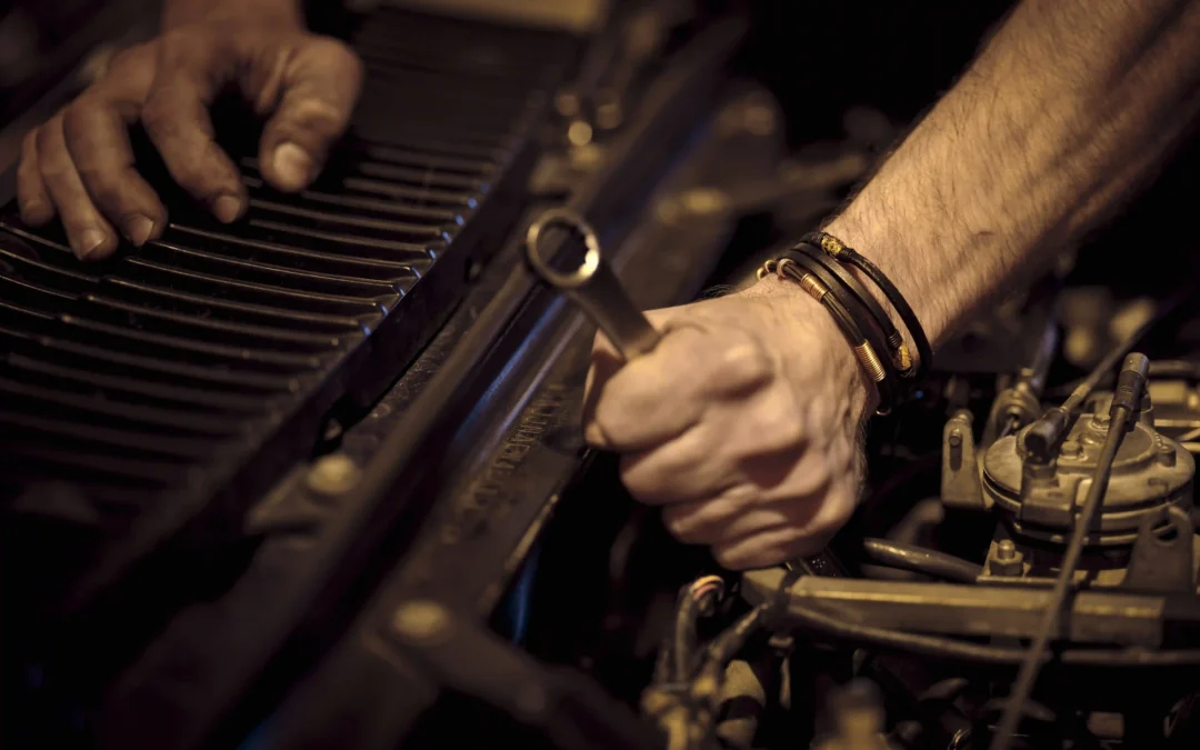 Mechanic inspecting a Toronto vehicle's exhaust system, checking the catalytic converter after a theft incident.